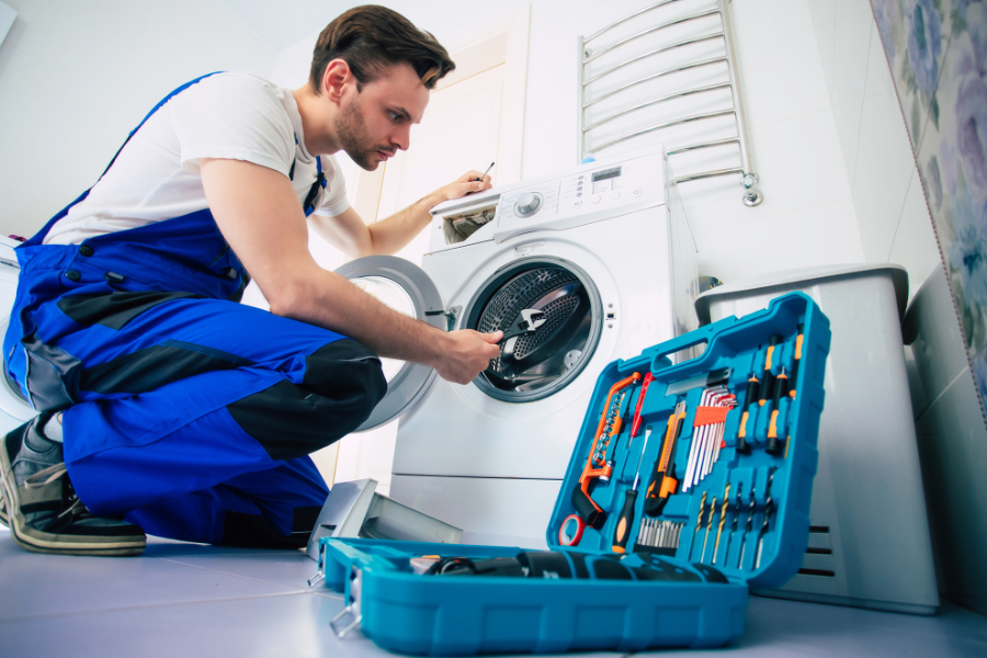 SpinFixx technician repairing a washing machine in Bangalore